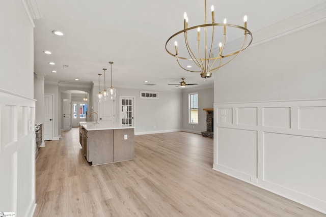 kitchen featuring ceiling fan with notable chandelier, visible vents, recessed lighting, and crown molding