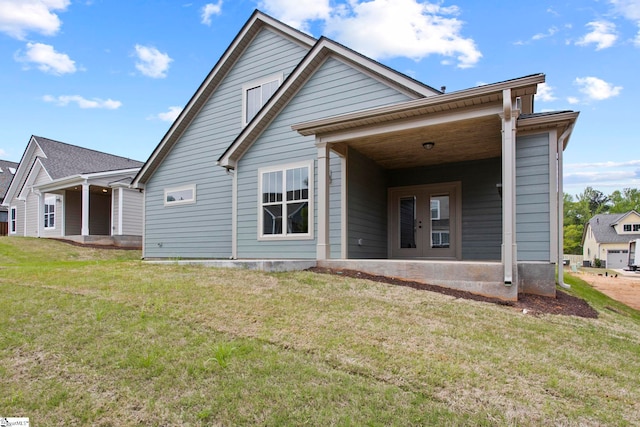 rear view of property with a yard