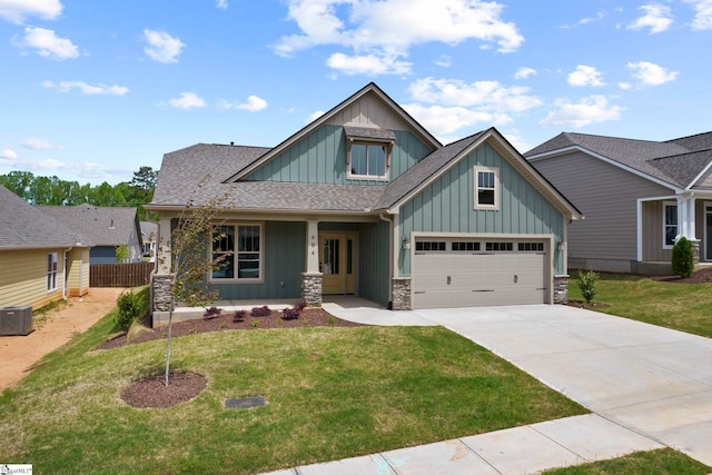 craftsman-style home featuring concrete driveway, a front lawn, stone siding, and board and batten siding