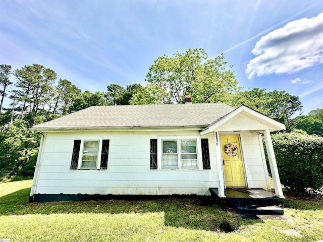 17920 Asheveille Hwy, Campobello, SC 29322 - view of front of house featuring a front lawn, roof with shingles, and a chimney