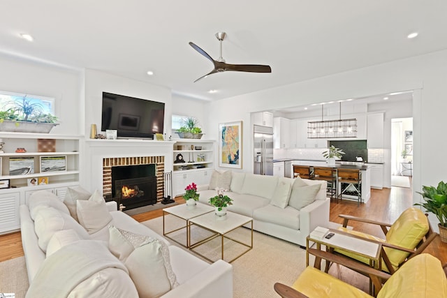 living area with recessed lighting and light wood-style flooring