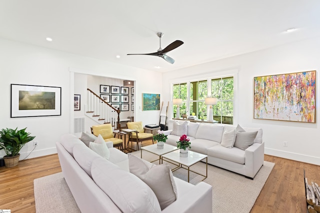 living room featuring recessed lighting, baseboards, a ceiling fan, and stairs