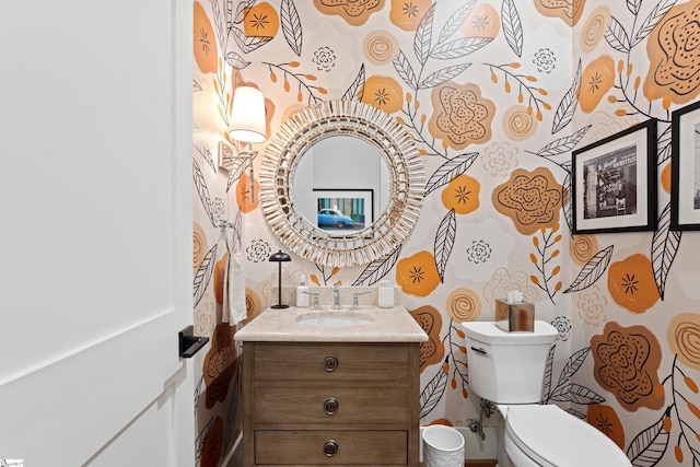 bathroom featuring toilet and vanity