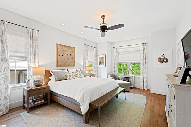 bedroom with baseboards, a ceiling fan, wood finished floors, and recessed lighting