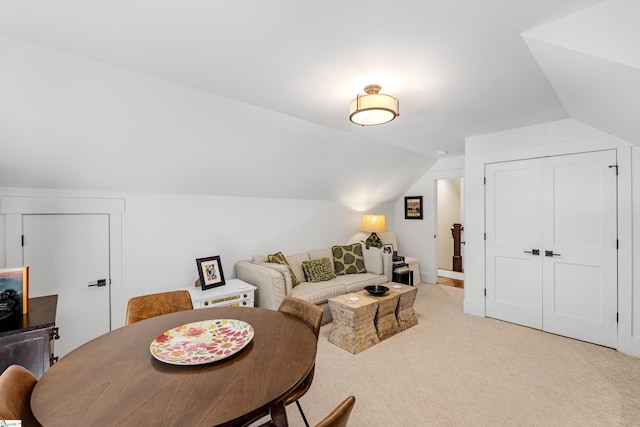 living room with lofted ceiling and light colored carpet