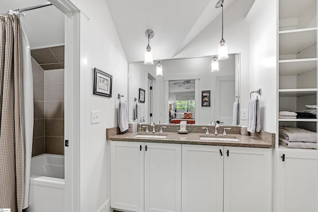 full bathroom with ensuite bathroom, a sink, double vanity, and a ceiling fan