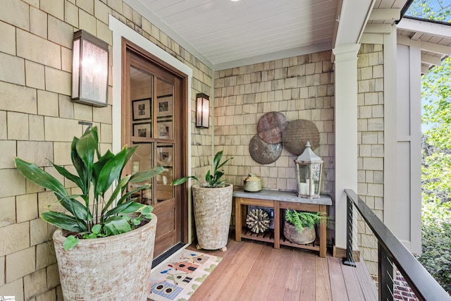 view of exterior entry featuring covered porch