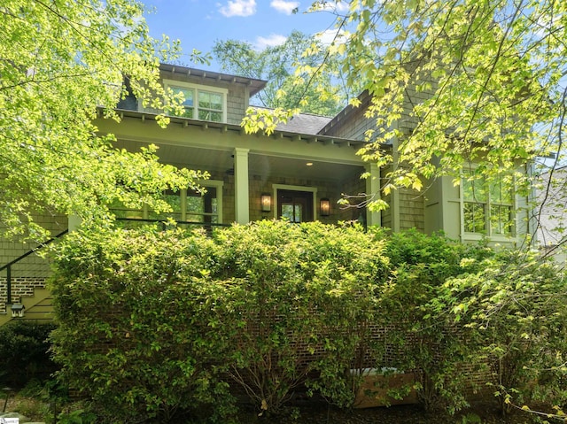 back of house featuring a porch