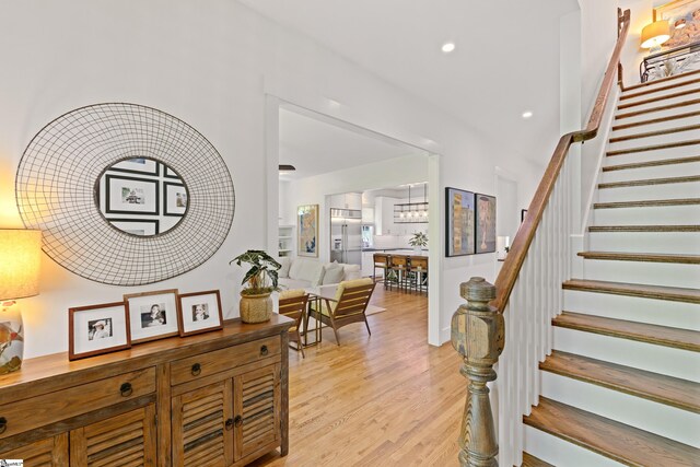 interior space with light wood finished floors, recessed lighting, and stairway