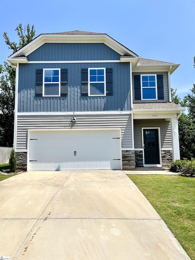 craftsman-style house featuring an attached garage, stone siding, a front yard, and concrete driveway