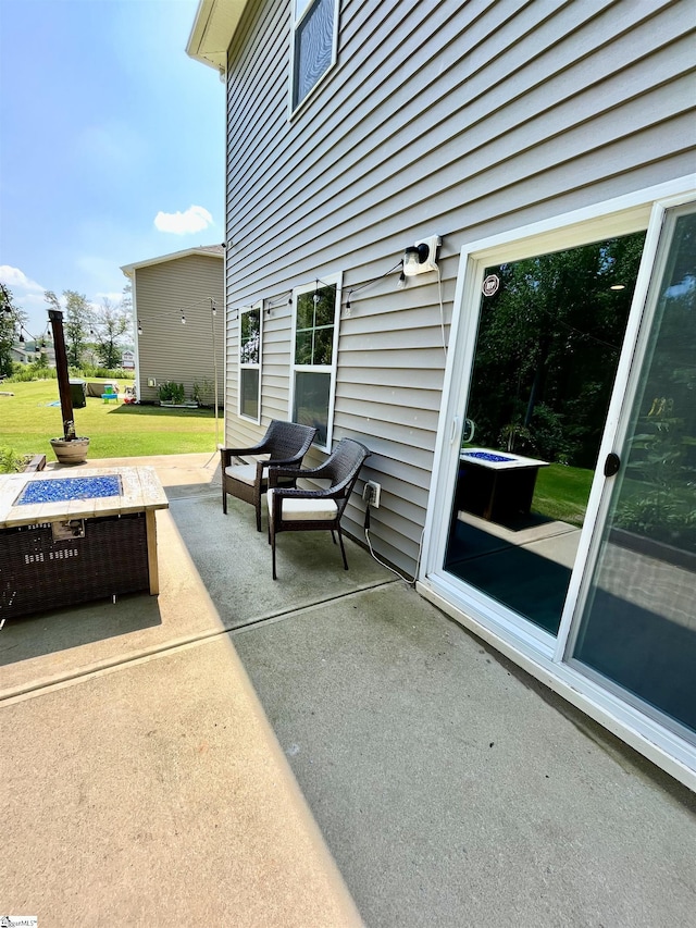view of patio / terrace with an outdoor fire pit