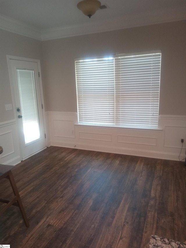 504 Airdale Ln, Simpsonville, SC 29680 - spare room featuring dark wood-type flooring, a decorative wall, ornamental molding, and wainscoting