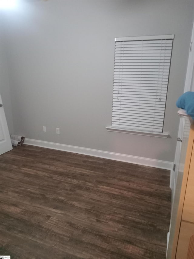 504 Airdale Ln, Simpsonville, SC 29680 - spare room featuring baseboards and dark wood-type flooring