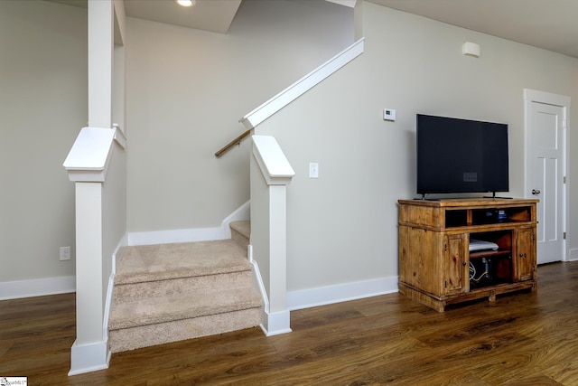 stairway with baseboards and wood finished floors