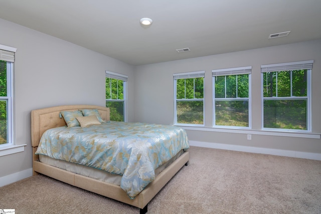 carpeted bedroom with baseboards and visible vents