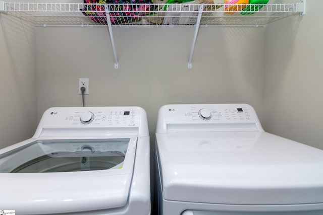laundry area with separate washer and dryer and laundry area