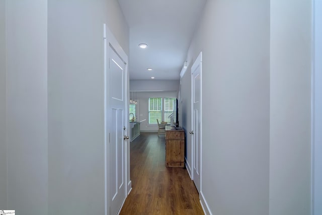 hall with baseboards, dark wood-type flooring, and recessed lighting