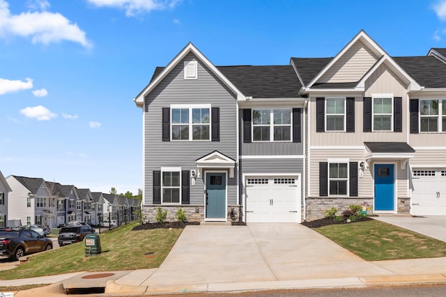 12 Hargrove Ct, Greenville, SC 29617 - townhome / multi-family property with a garage, driveway, stone siding, and a front yard