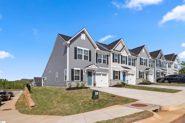 12 Hargrove Ct, Greenville, SC 29617 - townhome / multi-family property featuring a residential view, driveway, stone siding, an attached garage, and a front yard