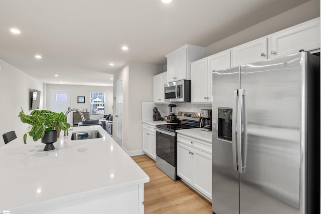 12 Hargrove Ct, Greenville, SC 29617 - kitchen with light countertops, appliances with stainless steel finishes, white cabinetry, and a sink