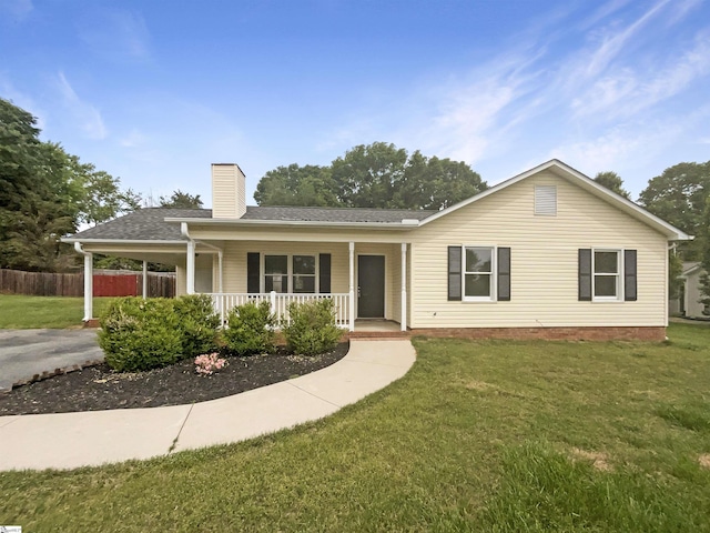 ranch-style home featuring a chimney, a front lawn, fence, and covered porch