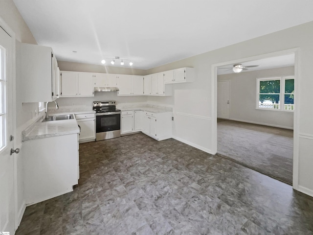 kitchen featuring a sink, stainless steel electric range oven, dark floors, light countertops, and under cabinet range hood