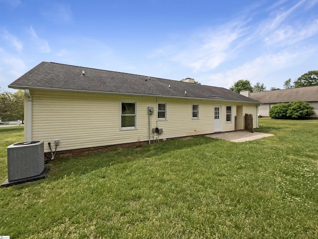 back of property featuring a yard, cooling unit, and a patio