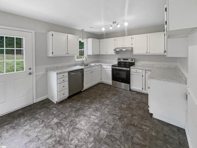 kitchen with a sink, stainless steel appliances, white cabinetry, dark floors, and under cabinet range hood