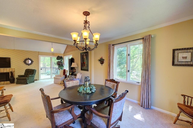 dining area featuring light carpet, baseboards, a wealth of natural light, and a notable chandelier