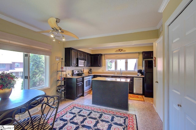 kitchen with stainless steel appliances, a ceiling fan, light countertops, and ornamental molding