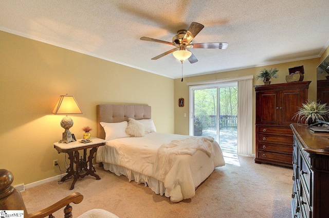 bedroom featuring access to outside, a textured ceiling, light colored carpet, and crown molding