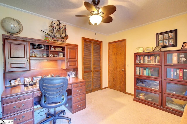 carpeted office space with a textured ceiling, crown molding, and ceiling fan