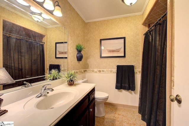 bathroom with toilet, ornamental molding, vanity, and baseboards