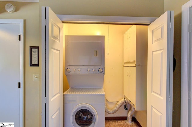 clothes washing area with stacked washing maching and dryer and laundry area