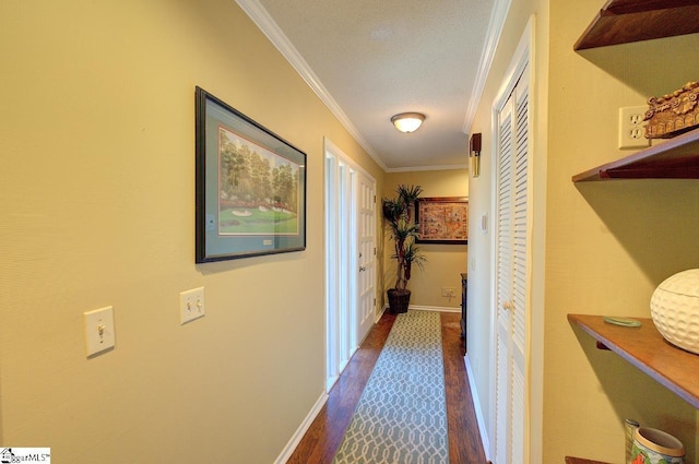 corridor with baseboards, ornamental molding, and dark wood-style flooring
