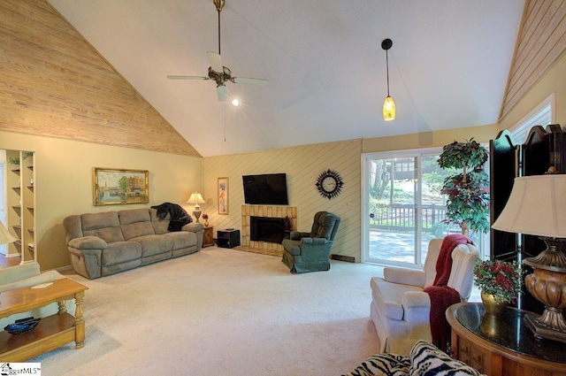 carpeted living room featuring a fireplace with flush hearth, an accent wall, high vaulted ceiling, and ceiling fan