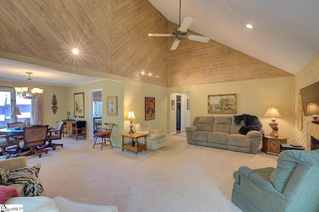 carpeted living room with high vaulted ceiling, a fireplace, recessed lighting, and ceiling fan with notable chandelier