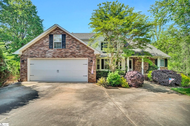 view of front of home featuring brick siding and concrete driveway