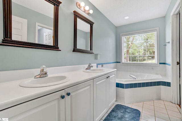 bathroom featuring tile patterned flooring, a garden tub, a sink, and double vanity