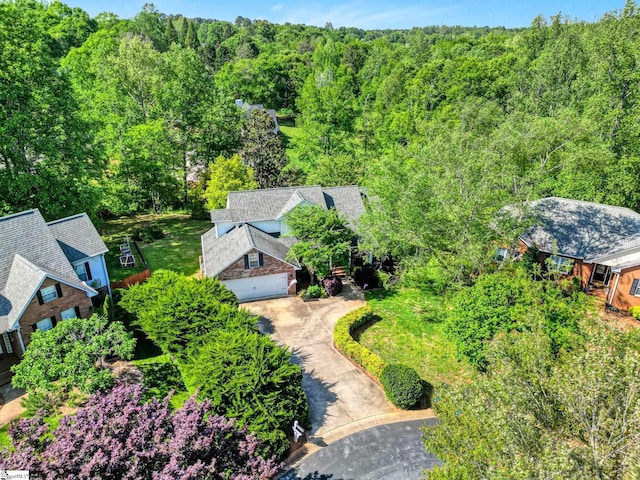 birds eye view of property with a forest view