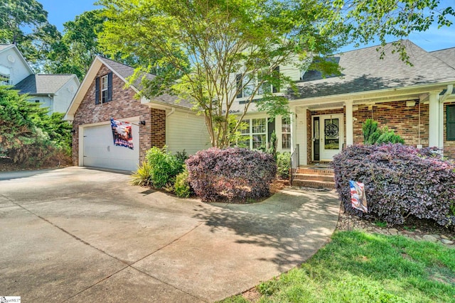 view of side of property with concrete driveway, brick siding, roof with shingles, and a garage
