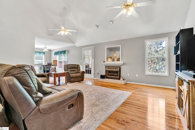 living room with lofted ceiling, light wood-type flooring, and ceiling fan
