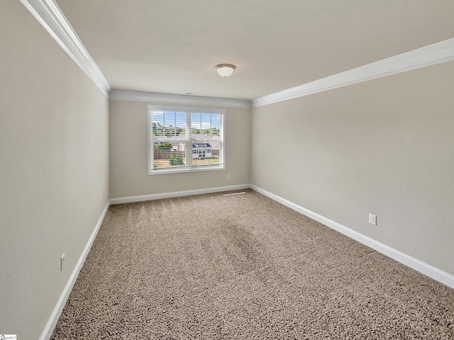 empty room featuring baseboards and ornamental molding