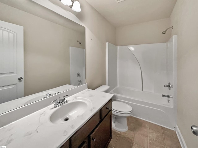 bathroom with toilet, vanity, tile patterned floors, and shower / bathing tub combination