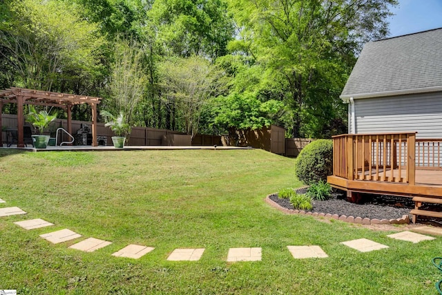 view of yard with a fenced backyard, a wooden deck, and a pergola
