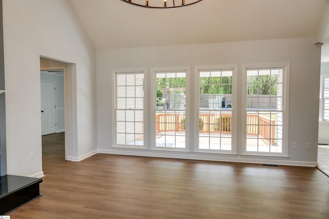 doorway with baseboards, dark wood-type flooring, and visible vents