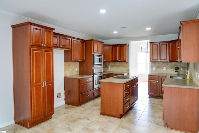 kitchen with a sink, crown molding, a center island, decorative backsplash, and appliances with stainless steel finishes