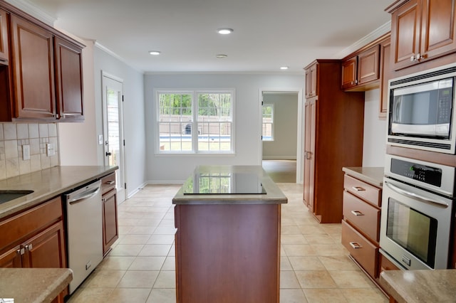 kitchen featuring backsplash, a kitchen island, appliances with stainless steel finishes, and light tile patterned floors