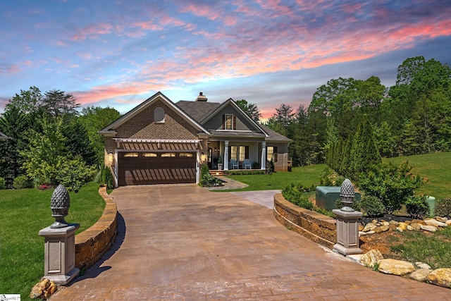 craftsman house with concrete driveway, a garage, and a lawn