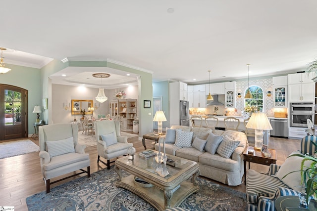 living area with light wood-type flooring, baseboards, recessed lighting, and crown molding